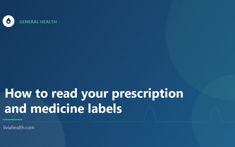 Person reading the label on a box of medicine